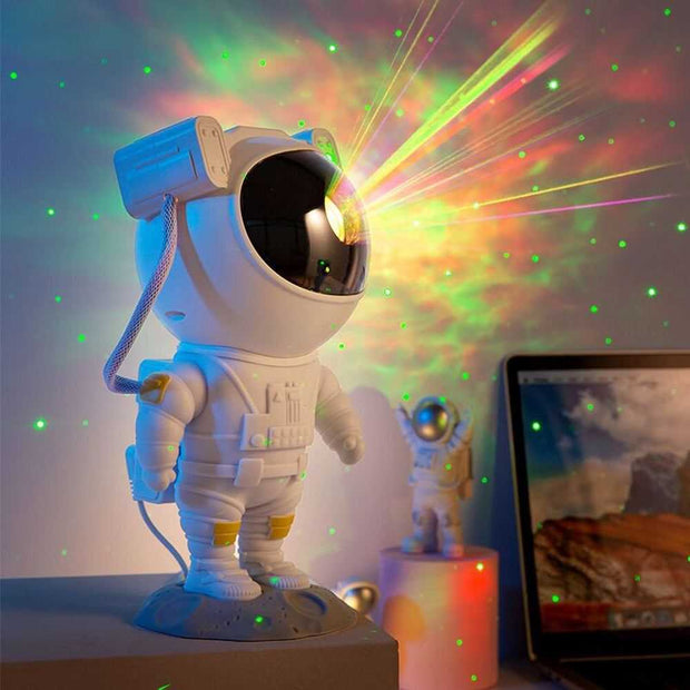 Astronaut galaxy projector nightlight illuminating colorful nebula and stars.