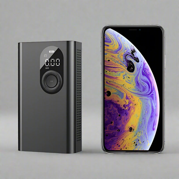 Portable wireless tire pump with digital display and smartphone for scale comparison.