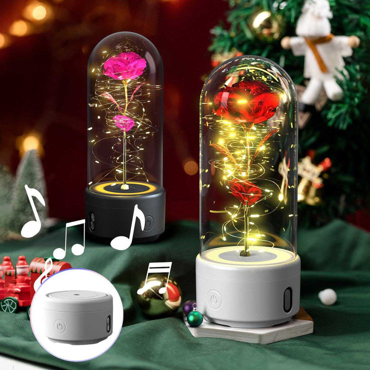 LED rose flower night light with Bluetooth-compatible speaker in glass cover.