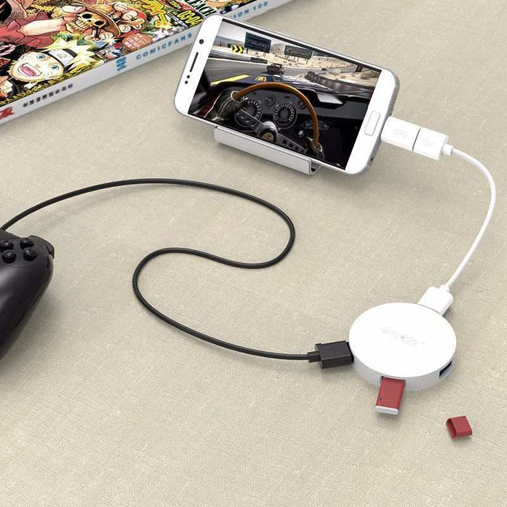 ORICO HA4U-U3 USB3.0 hub with connected smartphone and game controller.