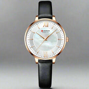 Ladies fashion watch with black genuine leather strap, round dial, and quartz movement.
