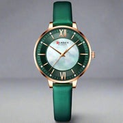 Ladies fashion watch with green genuine leather strap and round alloy case, featuring a quartz movement and waterproof design.