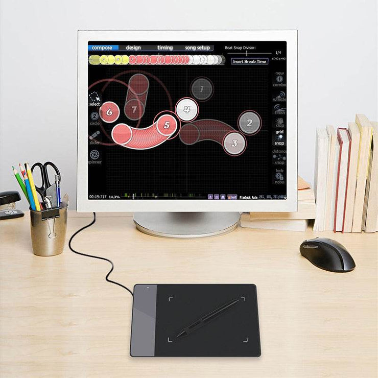 HUION 420 electronic drawing board connected to a computer, featuring a compact design ideal for digital art creation.