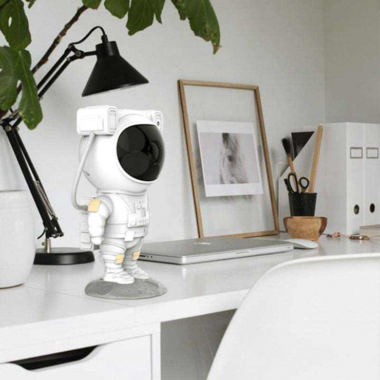 Astronaut galaxy projector lamp on desk, USB-powered starry sky decor.