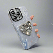 Silver rhinestone phone case with lens protector and heart bracket, compatible with iPhone.