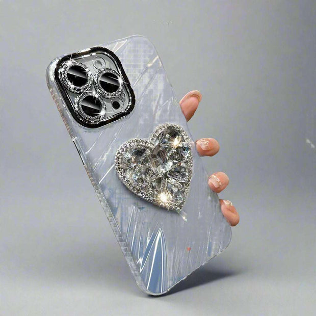 Silver rhinestone phone case with lens protector and heart bracket, compatible with iPhone.