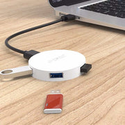 ORICO HA4U-U3 USB3.0 hub connected to laptop on desk.