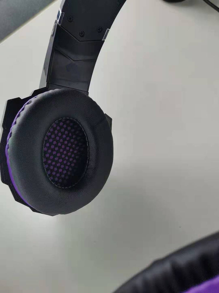 Wired gaming headset with plush earmuffs in purple.