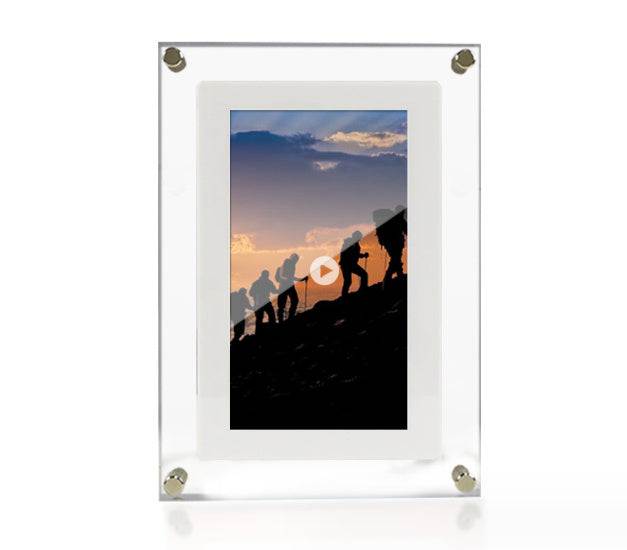 Vertical digital picture frame with acrylic design displaying a silhouette of people hiking at sunset.