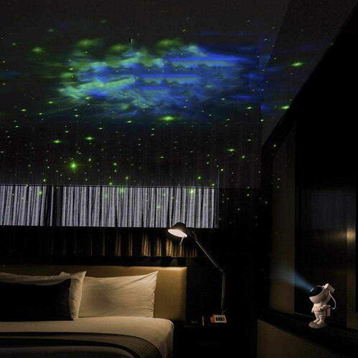 Astronaut galaxy projector creating starry night effect in bedroom.