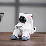 Cute astronaut phone stand made of resin, creative desktop holder for students.