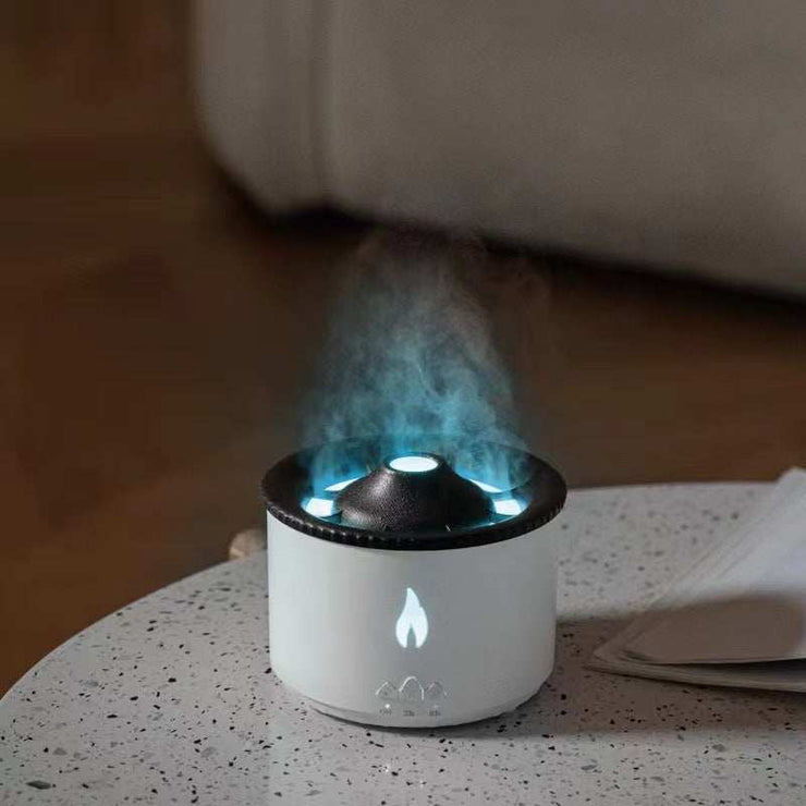 Ultrasonic essential oil diffuser with flame and jellyfish mist effect on a table.