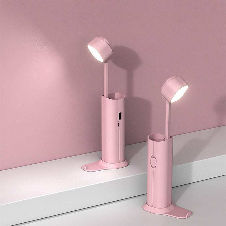 Portable pink desk lamp with flashlight and power bank functions.