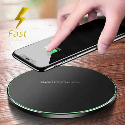 Wireless charger charging smartphone on fast charging pad.