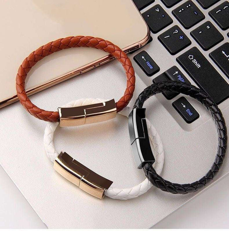 Braided leather bracelet charger cable in brown, white, and black, compatible with USB-C and iPhone.