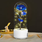 Creative 2-in-1 rose LED light and Bluetooth speaker in glass cover, perfect for romantic settings.