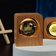 Beech wood crystal ball LED lamp with 3D laser engraved elk and jellyfish design on night stand.