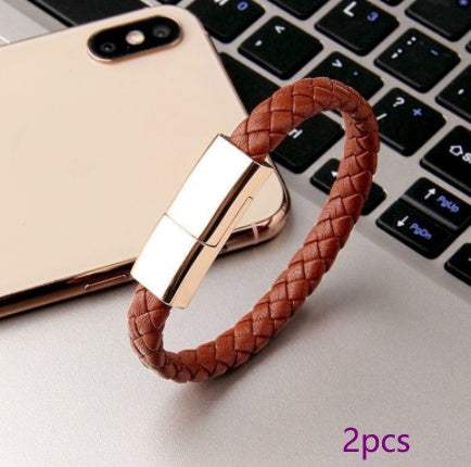 Braided leather bracelet charger on laptop, versatile USB charging cable.