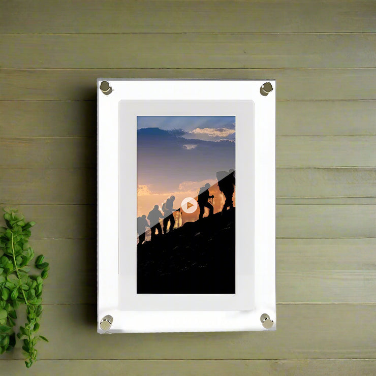 Acrylic digital picture frame with vertical display, featuring mountain climbers at sunset.