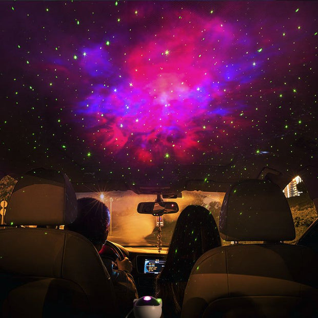 Astronaut galaxy projector displaying adjustable nebula and stars inside a car.