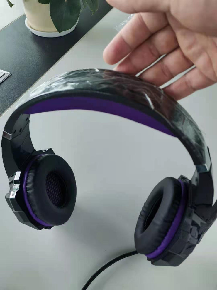 Wired gaming headset with USB plug, purple accents, and head-mounted design.